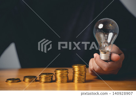 A closeup man hand pose presents a gesture as a sign for a creative idea and a good financial sign for business growth with stacked coins and increasing money savings A closeup man hand pose presents a gesture as a sign for a creative idea and a good financial sign for business growth with stacked coins and increasing money savings 140928907
