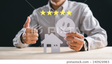 Person gives thumbs up displaying five stars for real estate house customer satisfaction concept, excellent property reviews and construction feedback, indicating best service for clients Person gives thumbs up displaying five stars for real estate house customer satisfaction concept, excellent property reviews and construction feedback, indicating best service for clients 140928963