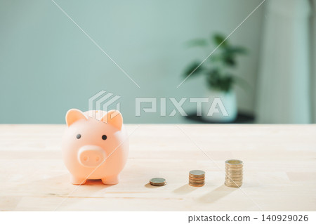 Piggy bank and increasing money stacks illustrate business growth, finance planning for future investment and long term savings, showing smart financial strategy Piggy bank and increasing money stacks illustrate business growth, finance planning for future investment and long term savings, showing smart financial strategy 140929026