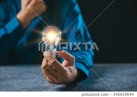 Hand holding lightbulb bulb light moment idea innovation business background concept symbolizes inspiration power digital creative thinking for professional growth and leadership Hand holding lightbulb bulb light moment idea innovation business background concept symbolizes inspiration power digital creative thinking for professional growth and leadership 140929044