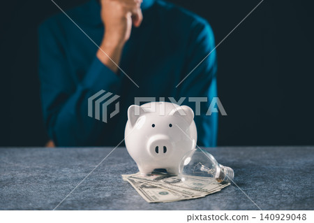 Innovation inspires financial growth through research while white piggy bank sits on money bills near lightbulb representing innovation, creative business idea and wealth concept Innovation inspires financial growth through research while white piggy bank sits on money bills near lightbulb representing innovation, creative business idea and wealth concept 140929048