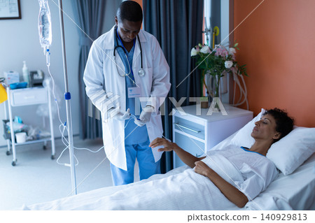 Male doctor injecting injection to female patients intravenous drip in the ward 140929813