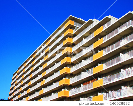 A typical Japanese scene: apartment buildings (multi-unit housing) against a blue sky. A typical Japanese scene: apartment buildings (multi-unit housing) against a blue sky. 140929952