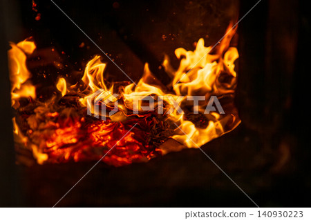 A close-up of the traditional Taiwanese temple ritual of burning joss paper and devout believers. A close-up of the traditional Taiwanese temple ritual of burning joss paper and devout believers. 140930223