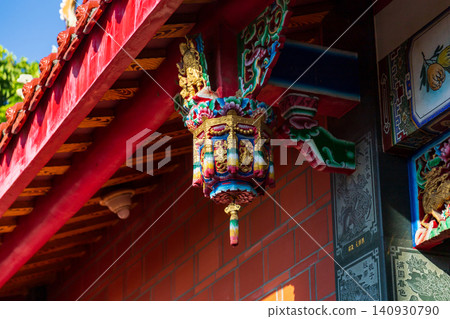 Close-up of the carved wooden hanging cylinders and painted beams and rafters of traditional Taiwanese temple architecture Close-up of the carved wooden hanging cylinders and painted beams and rafters of traditional Taiwanese temple architecture 140930790