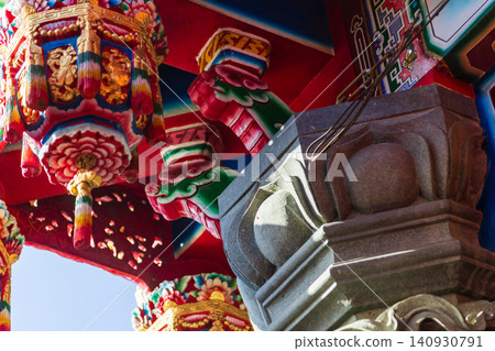 Close-up of the carved wooden hanging cylinders and painted beams and rafters of traditional Taiwanese temple architecture 140930791