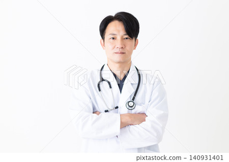 Middle-aged male doctor wearing a white coat Middle-aged male doctor wearing a white coat 140931401