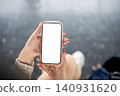 Close up of vertical smartphone mockup in woman hands. 140931620