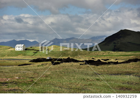 Lonely white house in a green mountain valley near Arnarstapi Iceland Lonely white house in a green mountain valley near Arnarstapi Iceland 140932259
