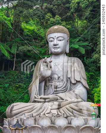 Giant seated Buddha statue at Chin Swee Caves Temple surrounded by tropical forest at Genting Highlands Malaysia Giant seated Buddha statue at Chin Swee Caves Temple surrounded by tropical forest at Genting Highlands Malaysia 140932443