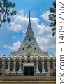 White Buddhist chedi with spire and ornate base at Wat Yanasangwararam temple in Chonburi Thailand 140932562