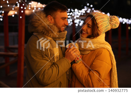 Happy couple spending time at Christmas fair 140932775