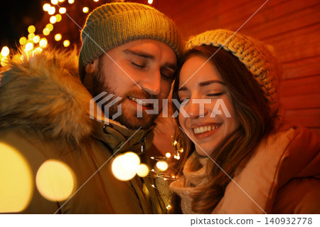 Happy couple spending time at Christmas fair Happy couple spending time at Christmas fair 140932778