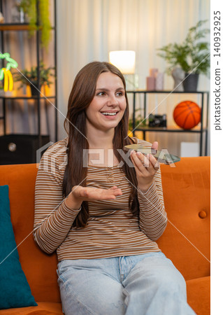 Young woman on speakerphone explains with confidence nods gestures listens and ends call with agreed Young woman on speakerphone explains with confidence nods gestures listens and ends call with agreed 140932925