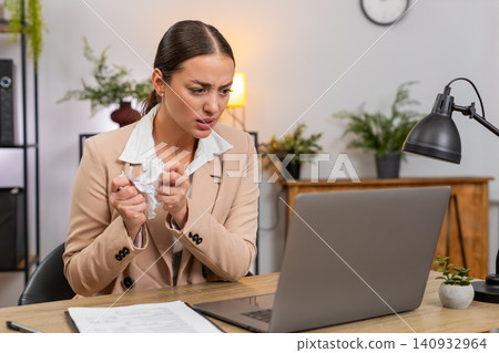 Young businesswoman hits workspace in anger crumples report exhales calms and returns to editing Young businesswoman hits workspace in anger crumples report exhales calms and returns to editing 140932964