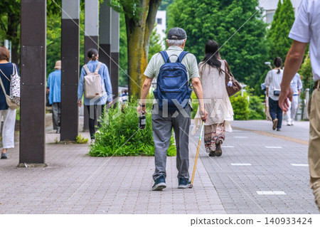 The urban landscape of Yokohama, Japan: An elderly man with a cane... An aging society, the meaning of life... = In Yokohama City The urban landscape of Yokohama, Japan: An elderly man with a cane... An aging society, the meaning of life... = In Yokohama City 140933424
