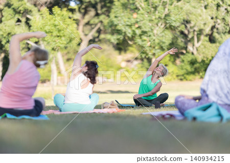 Group of senior women doing yoga outdoors Group of senior women doing yoga outdoors 140934215