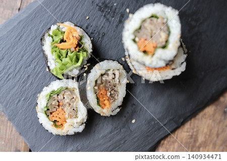 Korean seaweed rolls on a slate plate: Bulgogi Kimbap Korean seaweed rolls on a slate plate: Bulgogi Kimbap 140934471