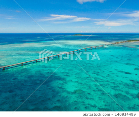 Ikema Ohashi Bridge spanning the emerald green sea (drone footage) 140934499