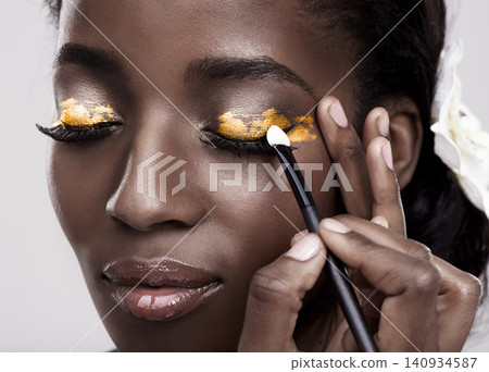 Brush, makeup and face of black woman in studio for wellness, beauty and aesthetic. Cosmetology, skincare and person with tools for makeover application, eyeshadow and products on a white background 140934587