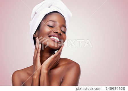 Hair, towel and happy black woman in studio for skincare, wellness or body care on pink background. Beauty, cleaning and hands on face of African female model with cosmetic, shine or glowing skin Hair, towel and happy black woman in studio for skincare, wellness or body care on pink background. Beauty, cleaning and hands on face of African female model with cosmetic, shine or glowing skin 140934628