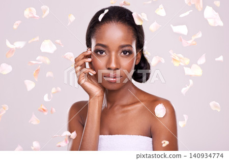 Portrait, skincare and petals with natural black woman in studio on pink background for wellness. Face, beauty and cosmetics with serious young aesthetic model at spa for dermatology treatment Portrait, skincare and petals with natural black woman in studio on pink background for wellness. Face, beauty and cosmetics with serious young aesthetic model at spa for dermatology treatment 140934774