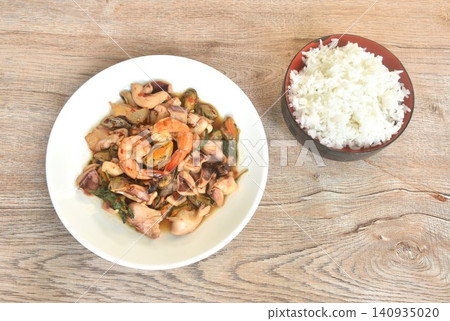 spicy fried shrimp and squid with mussel chili basil on plate eat with plain rice spicy fried shrimp and squid with mussel chili basil on plate eat with plain rice 140935020