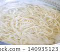Ramen noodles boiling in a pot 140935123