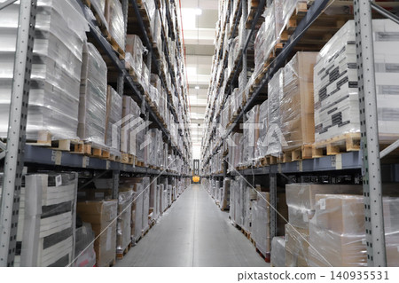 packing line in a logistics warehouse. conveyor belt in a modern production line. Pallet racking packing line in a logistics warehouse. conveyor belt in a modern production line. Pallet racking 140935531