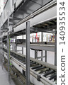 packing line in a logistics warehouse. conveyor belt in a modern production line. Pallet racking 140935534