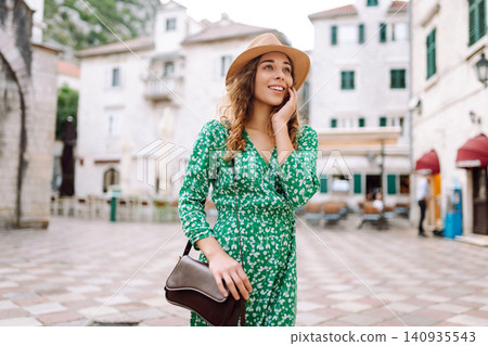 Young beautiful woman in trendy summer dress posing in street. Fashion style. Tourist attraction. 140935543