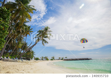 Tropical palm tree on beach with blue sky abstract background Tropical palm tree on beach with blue sky abstract background 140935710