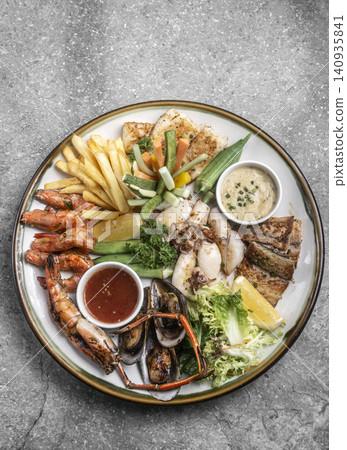 mixed mediterranean fish and seafood assortment plate on spanish restaurant table mixed mediterranean fish and seafood assortment plate on spanish restaurant table 140935841