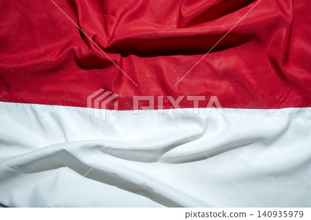 A crumpled red and white fabric texture resembling the national flag of Indonesia, ideal for Independence Day backgrounds. Hari Kemerdekaan, Merdeka, and Dirgahayu Indonesia on 17 Agustus A crumpled red and white fabric texture resembling the national flag of Indonesia, ideal for Independence Day backgrounds. Hari Kemerdekaan, Merdeka, and Dirgahayu Indonesia on 17 Agustus 140935979