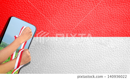 Celebrate Indonesian Independence Day with hands holding the red and white ribbon coming out of screen on a Indonesian flag background. Hari Kemerdekaan, Merdeka, and Dirgahayu Indonesia on 17 Agustus 140936022