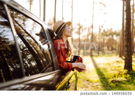 Happy woman in car window. Hair in wind. Road trip. Lifestyle, travel, tourism, nature, active life 140936030