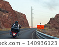 Equipped motorcyclists traveling on winding 140936123