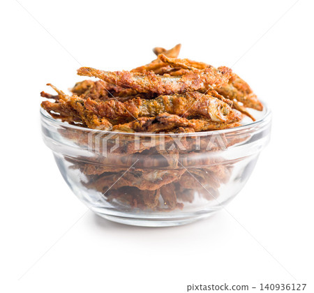 Crispy Fried Small Fish Snack Pile in Glass Bowl Golden Deep-Fried Seafood Appetizer Crispy Fried Small Fish Snack Pile in Glass Bowl Golden Deep-Fried Seafood Appetizer 140936127
