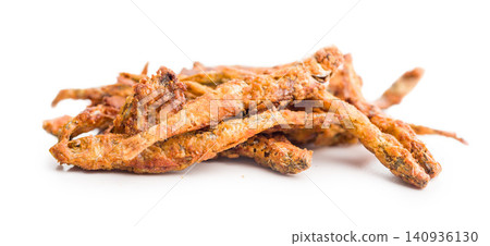 Crispy Fried smelts. Small Fish Snack Pile On White Background Closeup Golden Anchovy Appetizer Crispy Fried smelts. Small Fish Snack Pile On White Background Closeup Golden Anchovy Appetizer 140936130