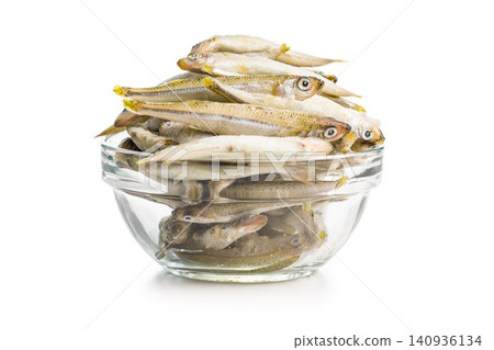 Frozen Small Fish in Glass Bowl on White Background - Seafood Whole Fish Pile Frozen Small Fish in Glass Bowl on White Background - Seafood Whole Fish Pile 140936134