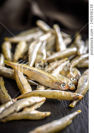 Fresh Small Fish Pile On Dark Surface Seafood Market Bait Smelt Raw Catch Fresh Small Fish Pile On Dark Surface Seafood Market Bait Smelt Raw Catch 140936138