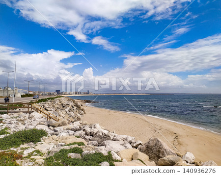 A peaceful coastal landscape features a sandy beach, rugged white rocks, and the deep blue ocean under a dramatic cloudy sky, evoking endless freedom and tranquility. Nobody. A peaceful coastal landscape features a sandy beach, rugged white rocks, and the deep blue ocean under a dramatic cloudy sky, evoking endless freedom and tranquility. Nobody. 140936276