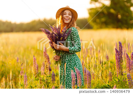 Young woman enjoying nature at sunset while walking. Nature concept. Young woman enjoying nature at sunset while walking. Nature concept. 140936479