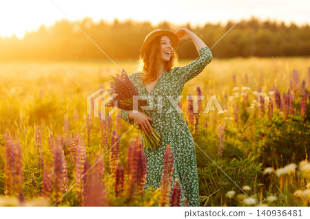 Young woman enjoying nature at sunset while walking. Nature concept. Young woman enjoying nature at sunset while walking. Nature concept. 140936481