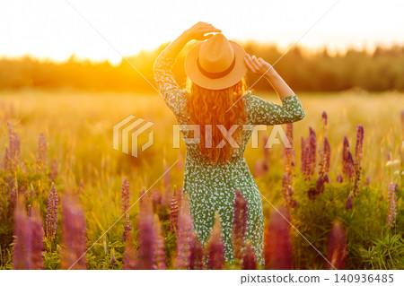 Young woman enjoying nature at sunset while walking. Nature concept. Young woman enjoying nature at sunset while walking. Nature concept. 140936485
