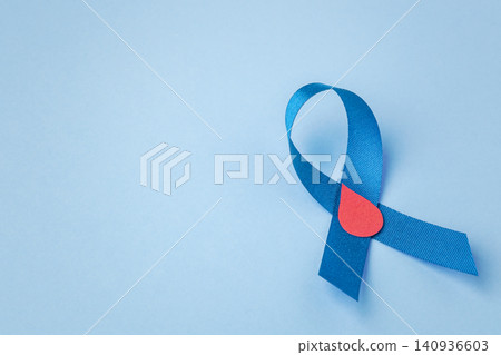 Blue ribbon with a red blood drop on a blue background with copy space, World Diabetes Day awareness concep Blue ribbon with a red blood drop on a blue background with copy space, World Diabetes Day awareness concep 140936603