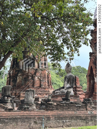 Historic Seated Buddha Image Surrounded By Crumbled Stone Pillars. Historic Seated Buddha Image Surrounded By Crumbled Stone Pillars. 140936802