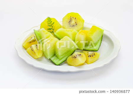 A fruit platter featuring ripe melon and golden kiwi. 140936877