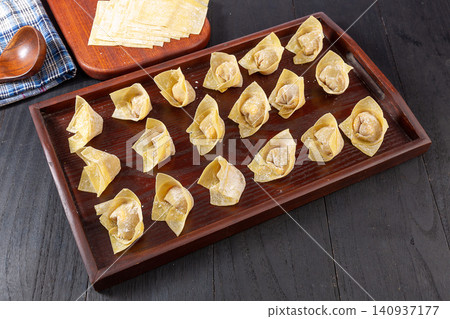 raw Wrapped Wontons Ready for Cooking, Traditional Chinese Dumplings 140937177