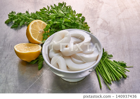Bowl of calamares with parsley and lemon 140937436
